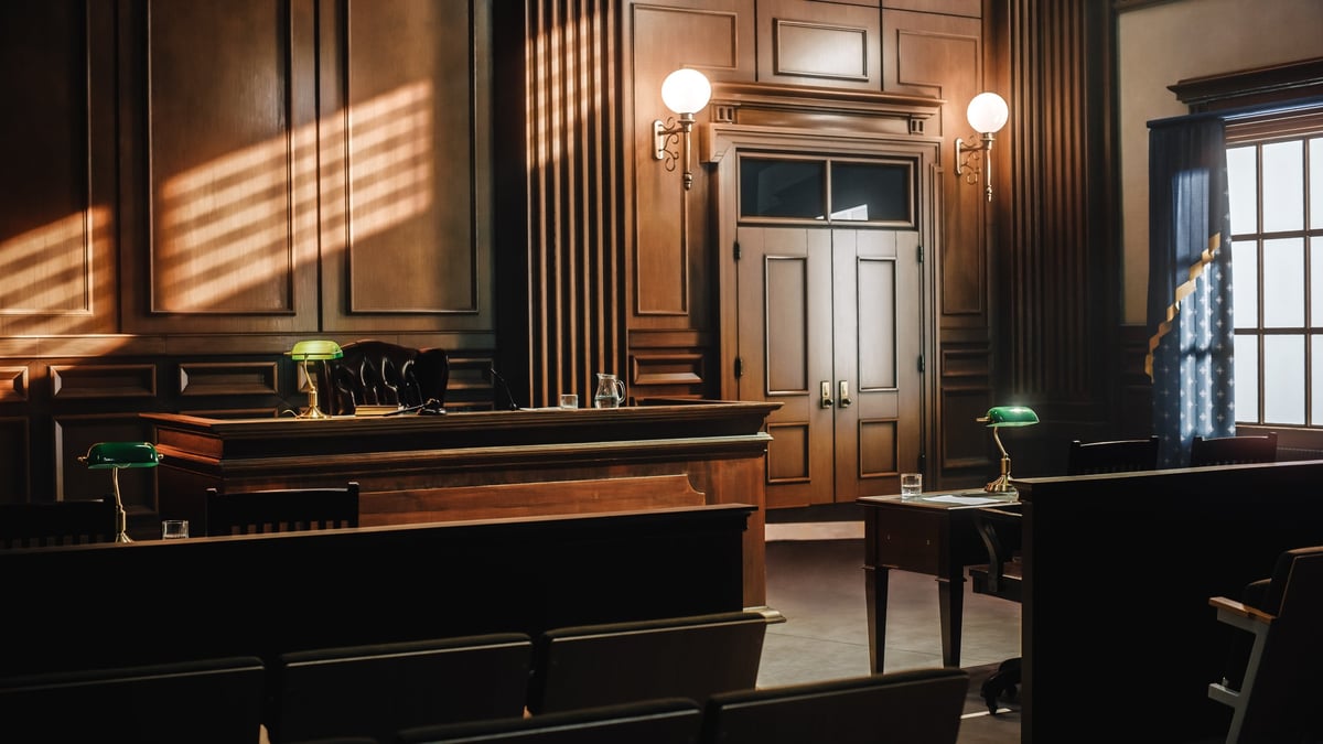 Free Legal Aid Magistrates' Court solicitor providing representation in a Magistrates Court courtroom with judge's bench and advocacy area