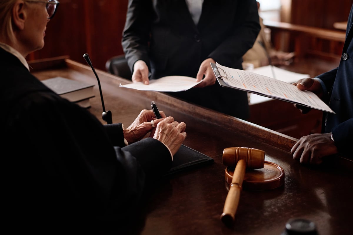 Defence solicitor for failing to surrender to court discussing documents with a judge and client in a legal meeting