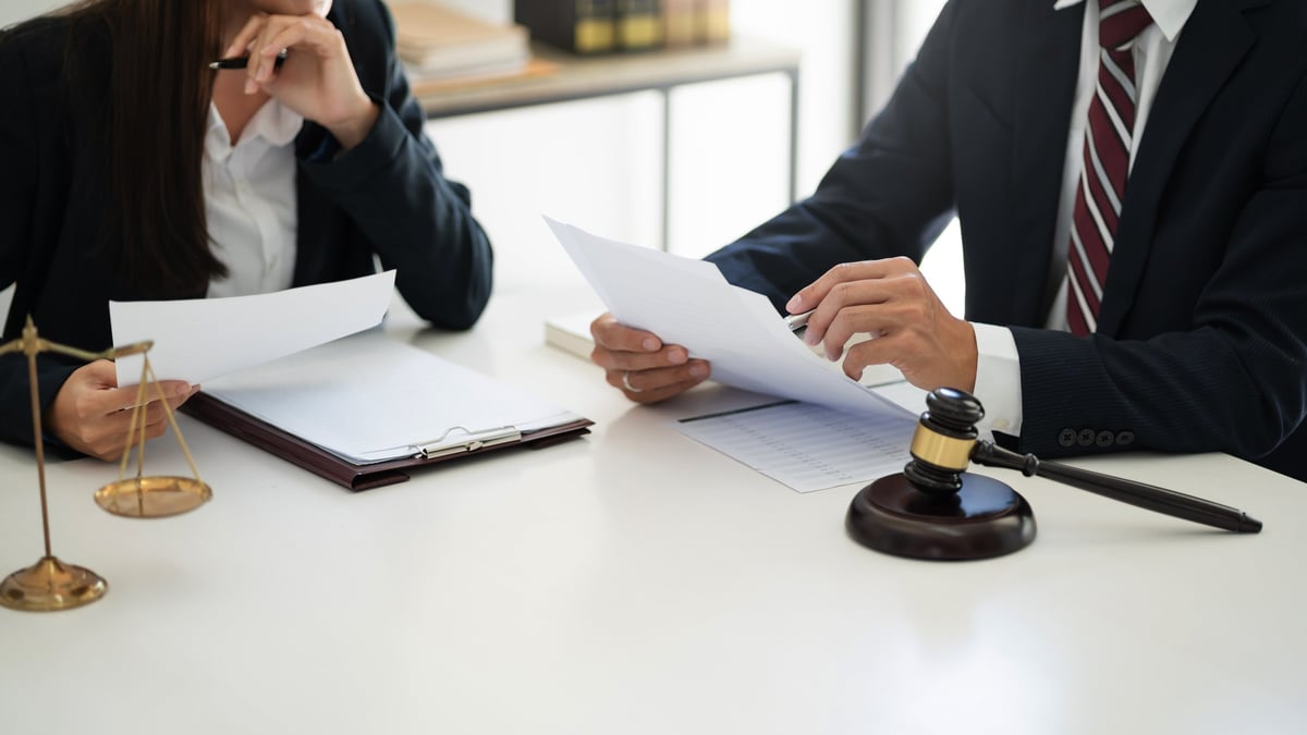 Solicitor for breach of bail meeting a client to discuss bail conditions and court attendance in a legal office