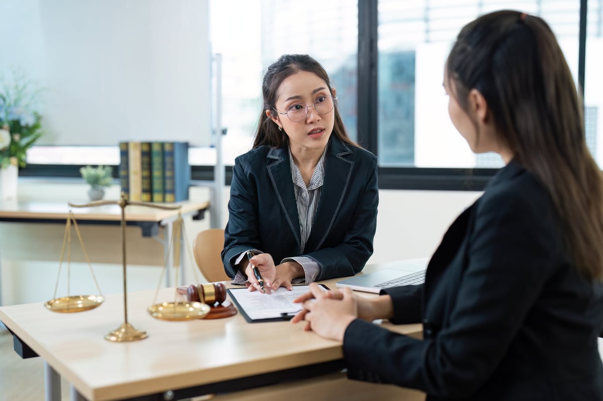 Free legal aid criminal law advice consultation with a professional solicitor discussing legal documents in a modern office