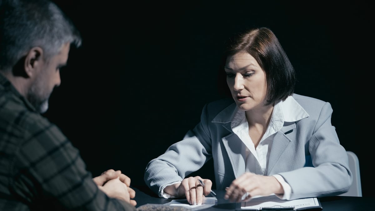 Criminal defence solicitors for witness intimidation charges reviewing evidence with a client