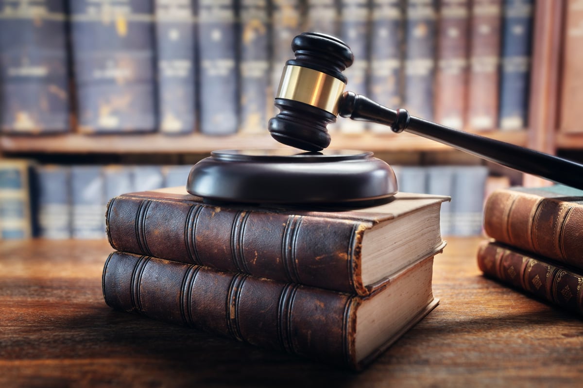 Judge gavel and law books representing fraud in UK criminal law under the Fraud Act 2006