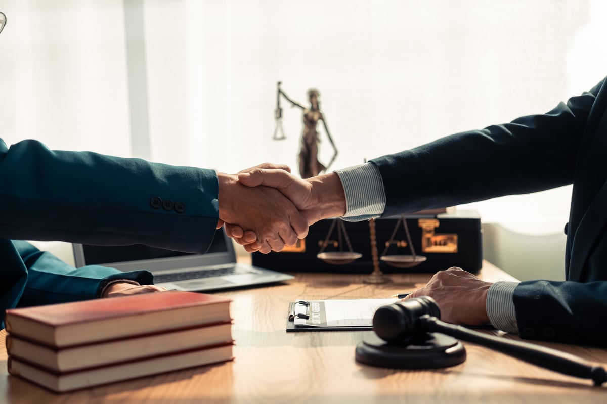 Free Legal Aid criminal defence services solicitor shaking hands with client representing trust, legal representation and criminal defence justice