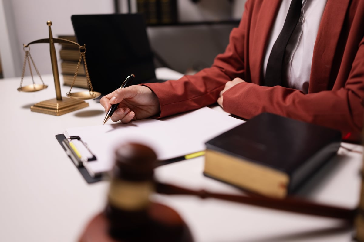 Solicitors for possession of drugs reviewing legal documents at a desk