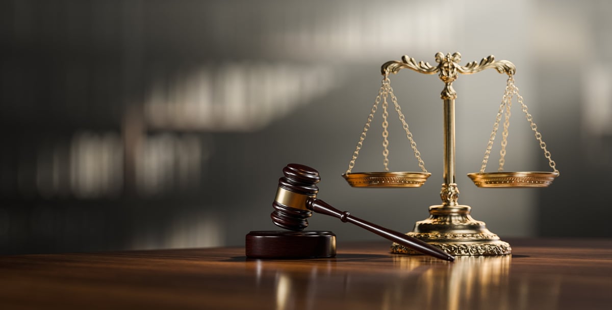 Fraud case defence solicitors explaining the legal process - scales of justice and gavel as symbols of criminal law