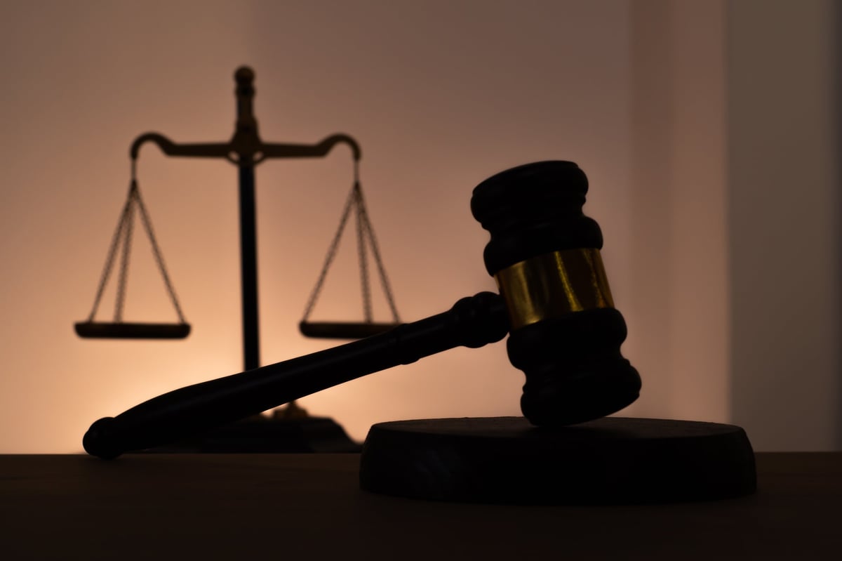 Criminal defence solicitor for manslaughter case at Crown Court with gavel and scales of justice