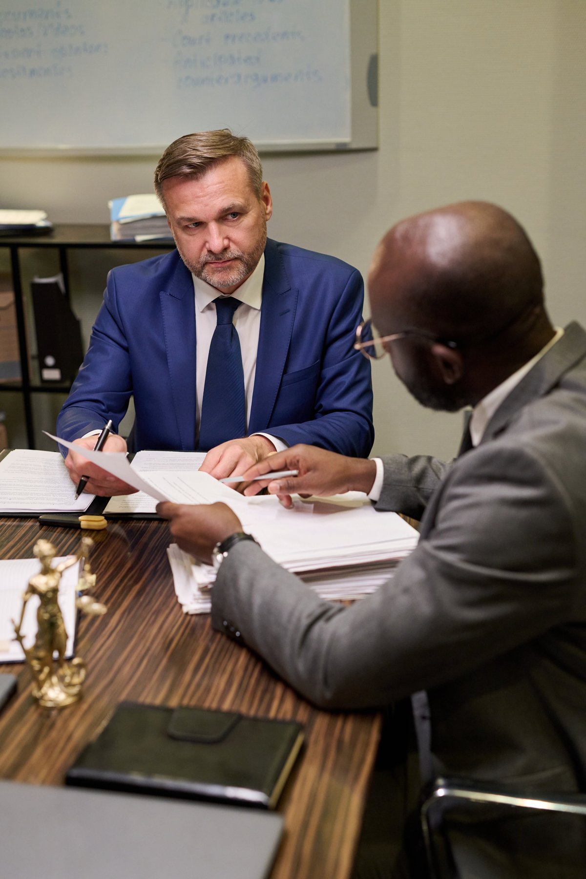 Free legal aid solicitor at Woolfe and Co providing expert fraud charge defence advice during a professional consultation with a client
