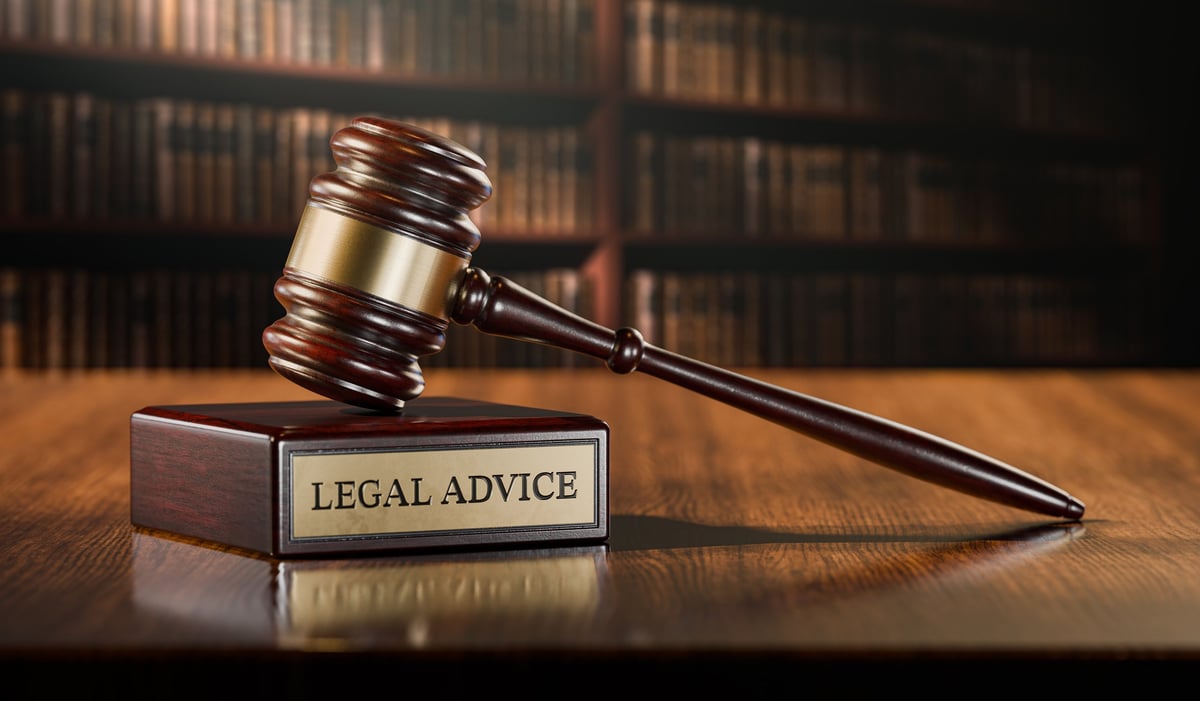 Solicitors for robbery charges reviewing legal case files at a desk with a judge gavel