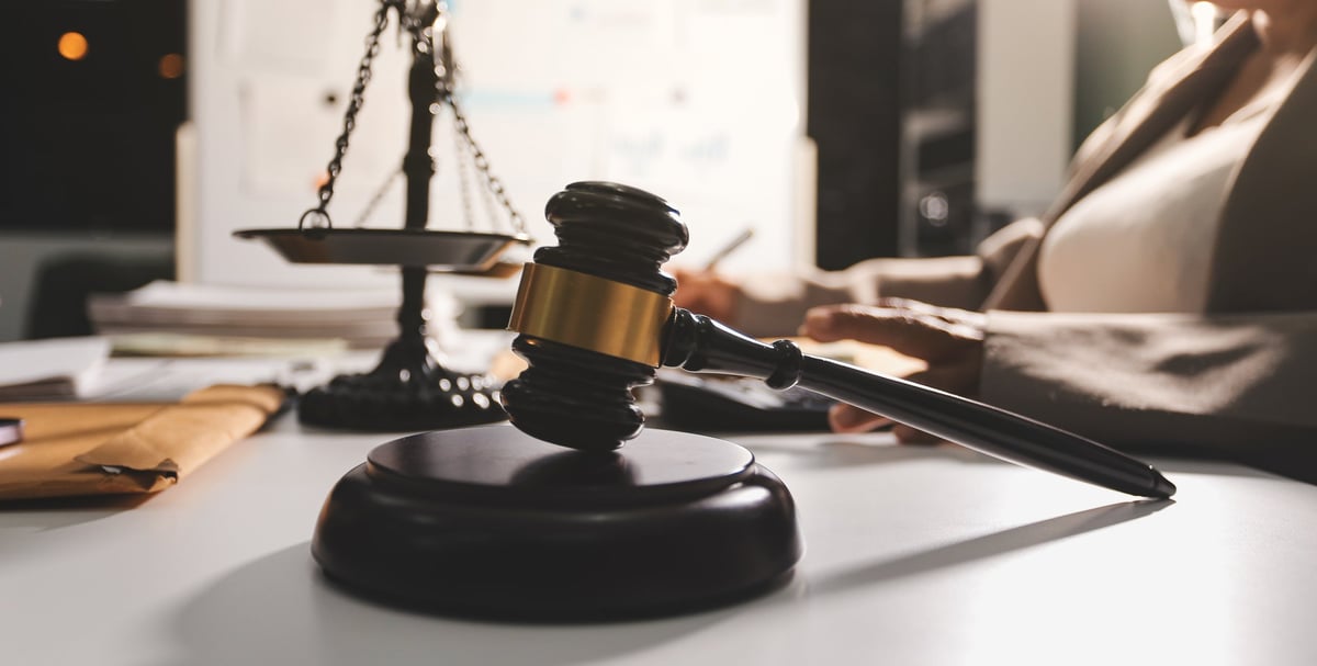 Criminal defence lawyers for perverting the course of justice in a case conference with legal papers and a gavel