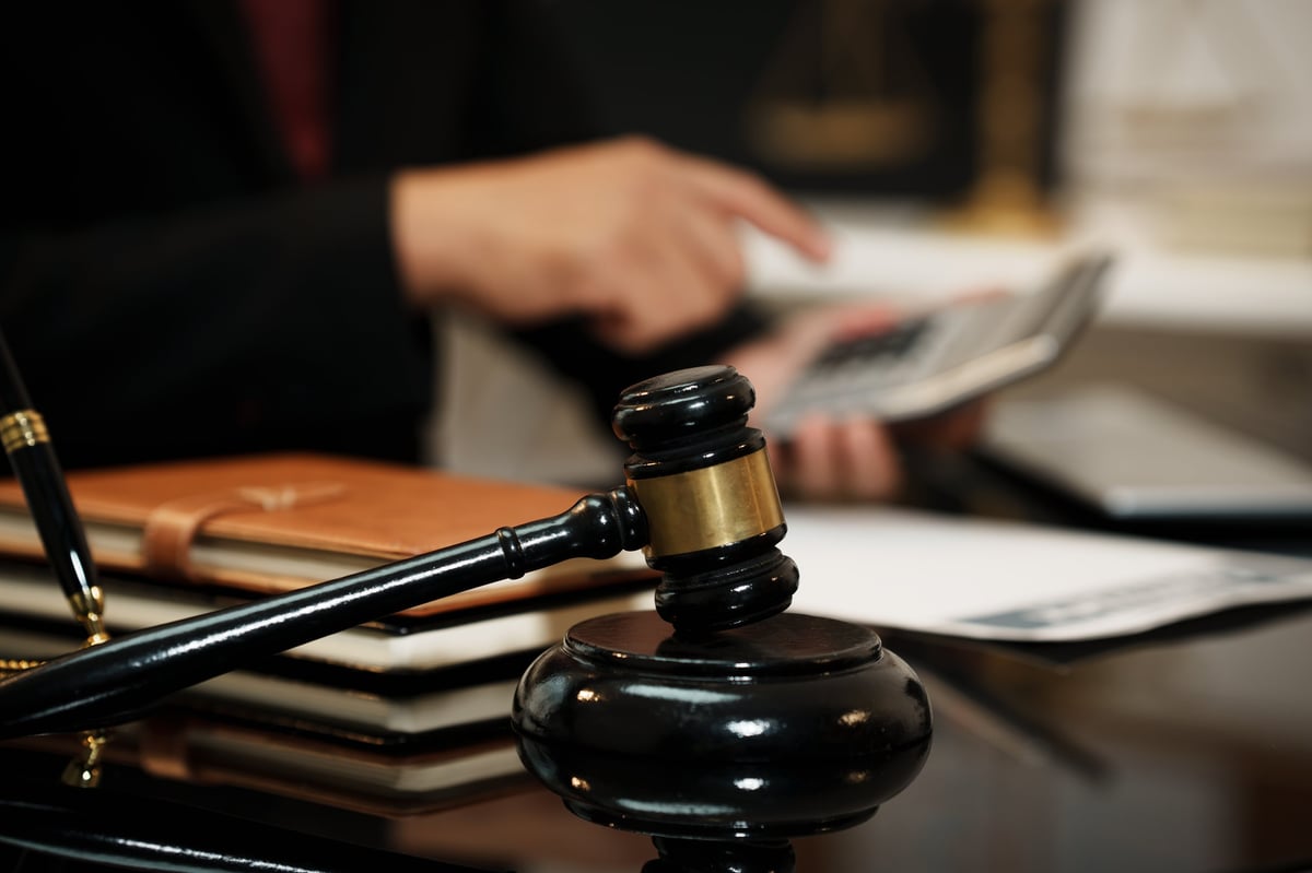 Solicitors for false accounting fraud criminal charge analysing financial documents and legal evidence at desk